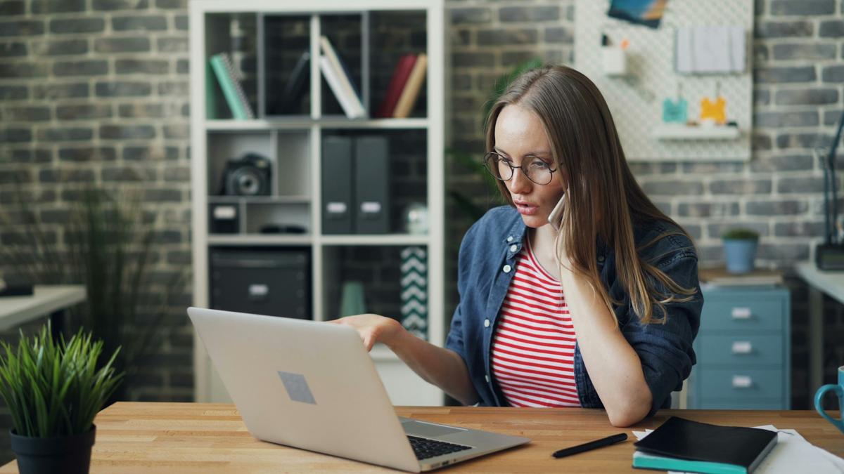 Homeowner discussing builder contract documents at the laptop